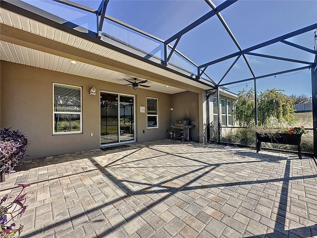 view of patio featuring area for grilling, a lanai, and ceiling fan