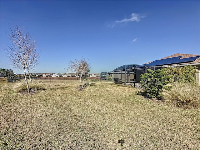 view of yard with glass enclosure