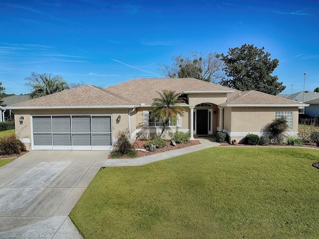 single story home featuring a garage and a front yard