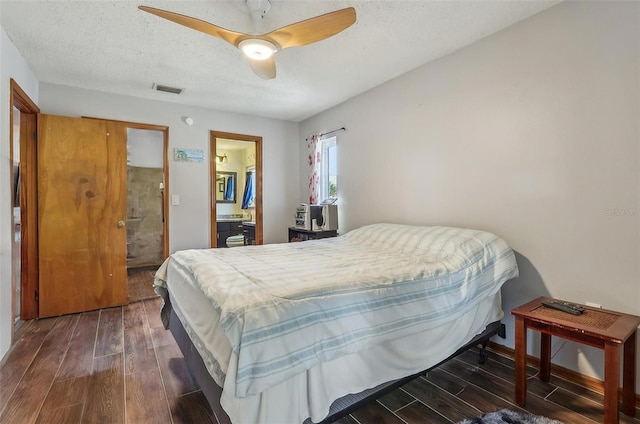 bedroom featuring dark hardwood / wood-style flooring, ceiling fan, and a textured ceiling