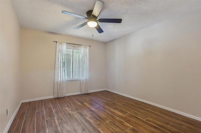 spare room with ceiling fan, dark wood-type flooring, and a textured ceiling