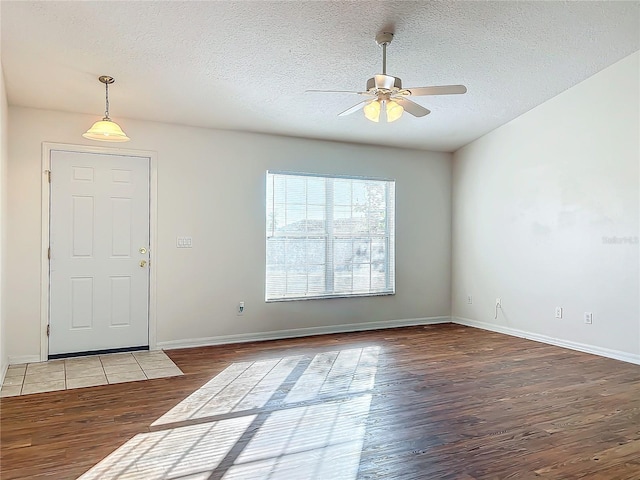 foyer entrance featuring ceiling fan, light hardwood / wood-style floors, and a textured ceiling