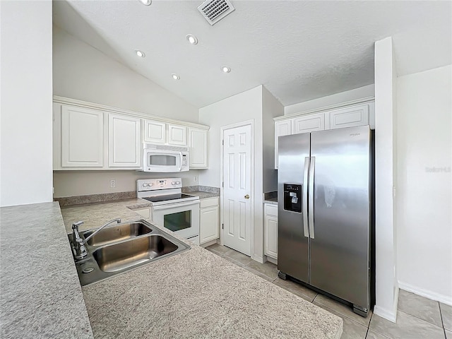 kitchen with sink, white cabinets, and white appliances