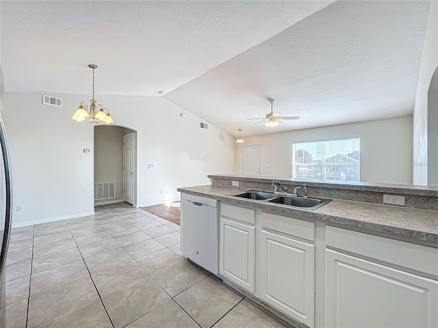 kitchen featuring ceiling fan with notable chandelier, white cabinetry, lofted ceiling, sink, and white dishwasher