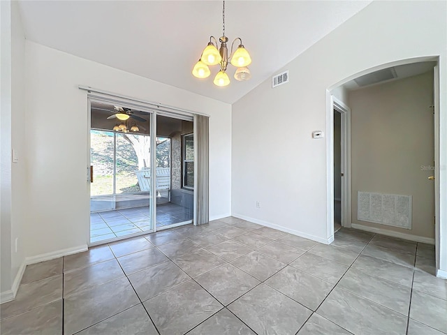 tiled empty room featuring lofted ceiling and a chandelier