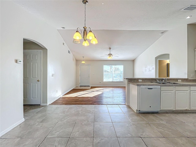 kitchen featuring hanging light fixtures, lofted ceiling, sink, and white dishwasher