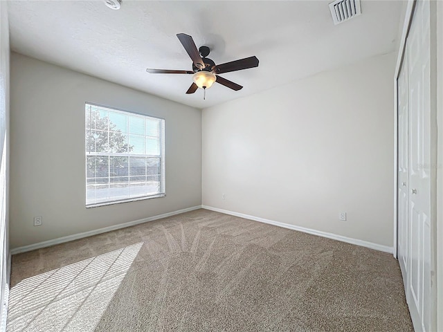 carpeted empty room with ceiling fan