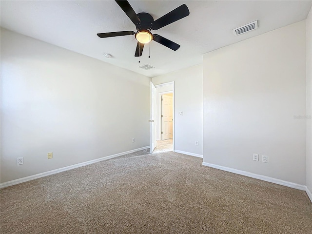 empty room featuring ceiling fan and carpet