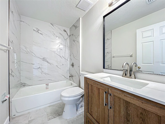 full bathroom with vanity, toilet, a textured ceiling, and tiled shower / bath