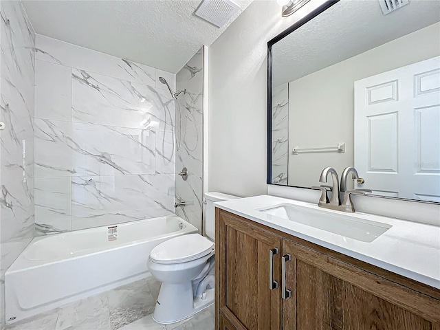 full bathroom featuring vanity, toilet, tiled shower / bath combo, and a textured ceiling