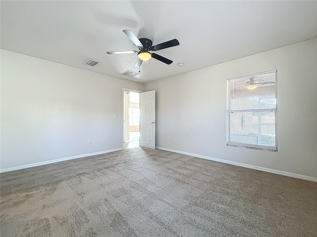 unfurnished room with ceiling fan and carpet flooring