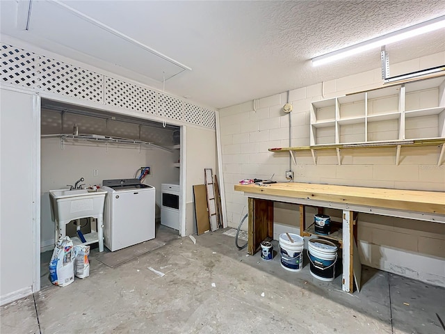 interior space with washer / clothes dryer, sink, and a textured ceiling