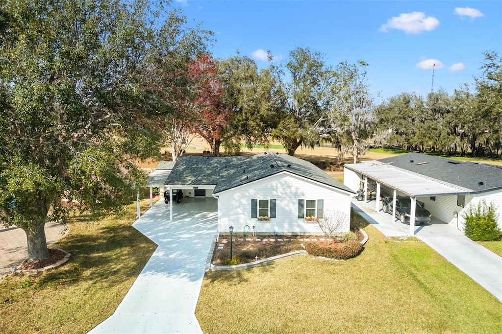 view of front facade featuring a front lawn and a carport