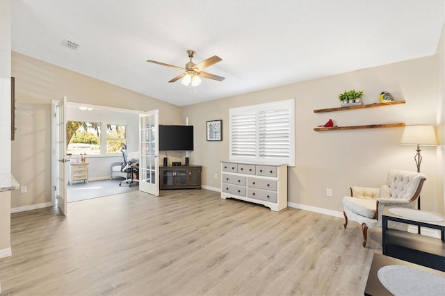 sitting room with vaulted ceiling, ceiling fan, and light hardwood / wood-style floors