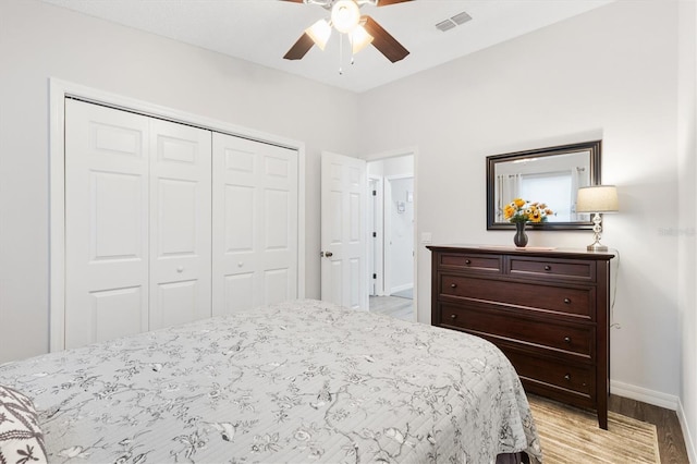 bedroom with ceiling fan, a closet, and light hardwood / wood-style flooring