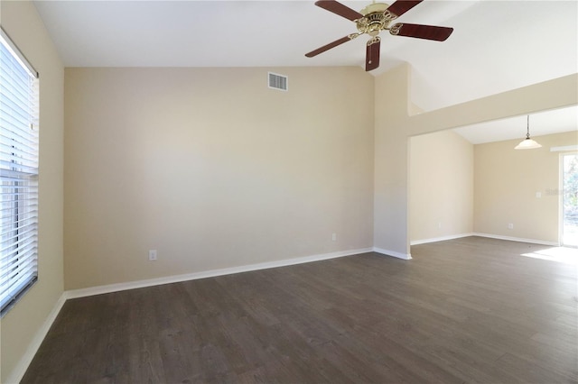 spare room with ceiling fan, dark hardwood / wood-style floors, and vaulted ceiling