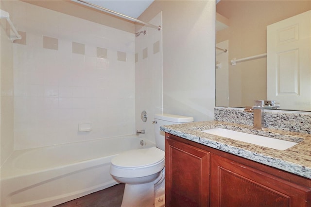 full bathroom with vanity, tiled shower / bath combo, and toilet