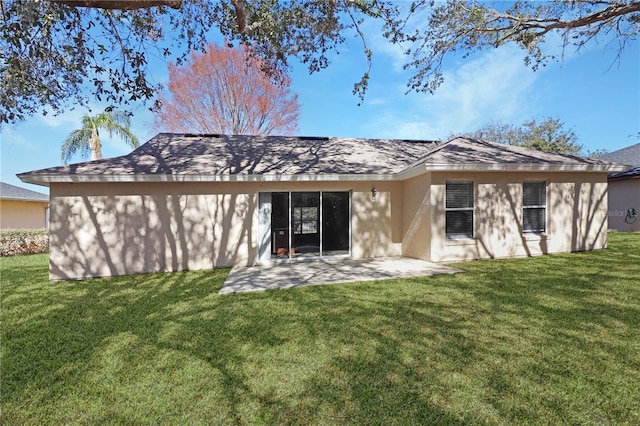 rear view of house featuring a yard and a patio area