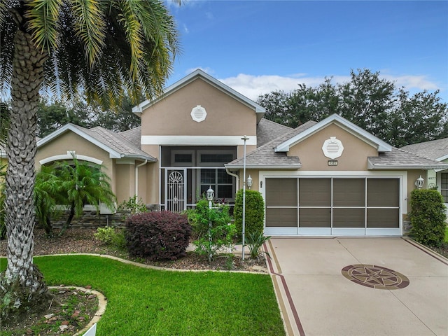 view of front of property featuring a garage and a front lawn