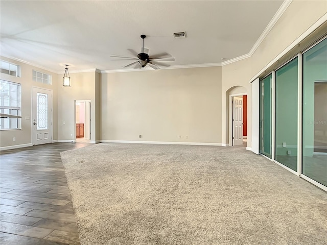 unfurnished living room featuring crown molding, ceiling fan, and dark hardwood / wood-style flooring