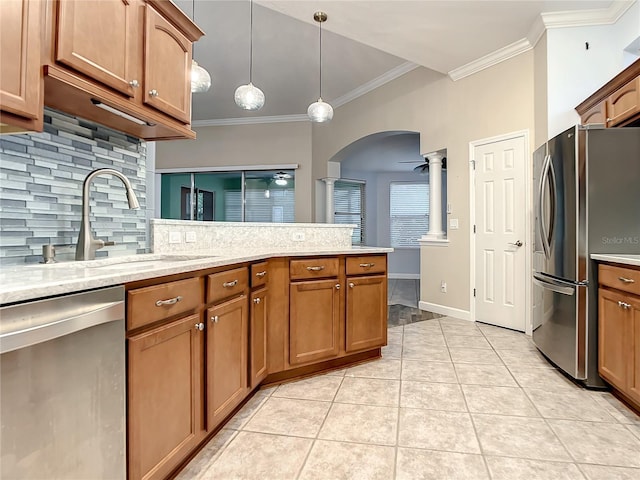 kitchen with pendant lighting, sink, light tile patterned floors, crown molding, and stainless steel appliances