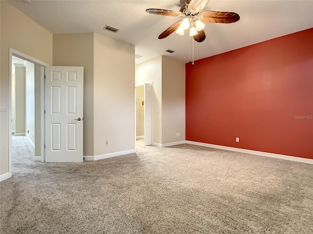 carpeted spare room featuring a textured ceiling and ceiling fan