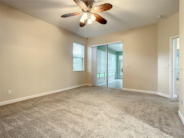 carpeted spare room with ceiling fan and a textured ceiling