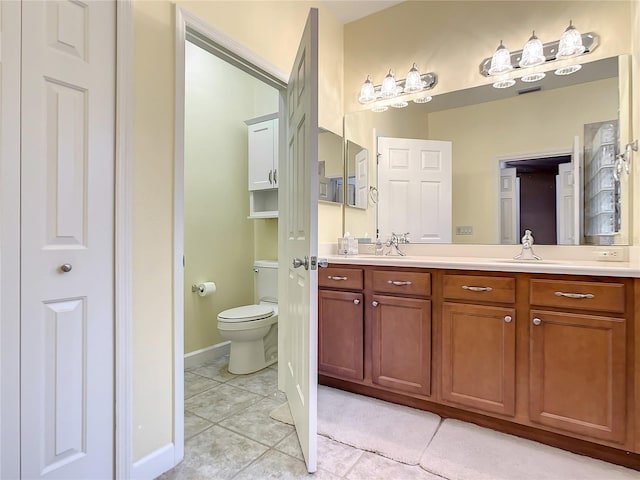 bathroom with vanity, tile patterned floors, and toilet