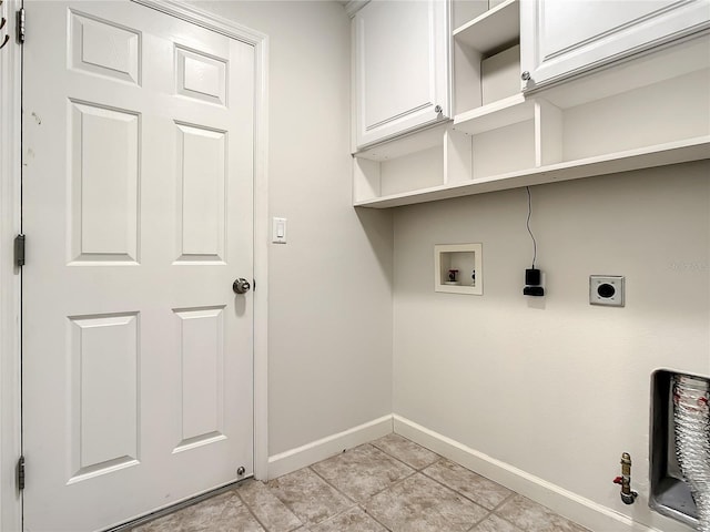 laundry area featuring cabinets, hookup for a gas dryer, light tile patterned floors, hookup for a washing machine, and electric dryer hookup