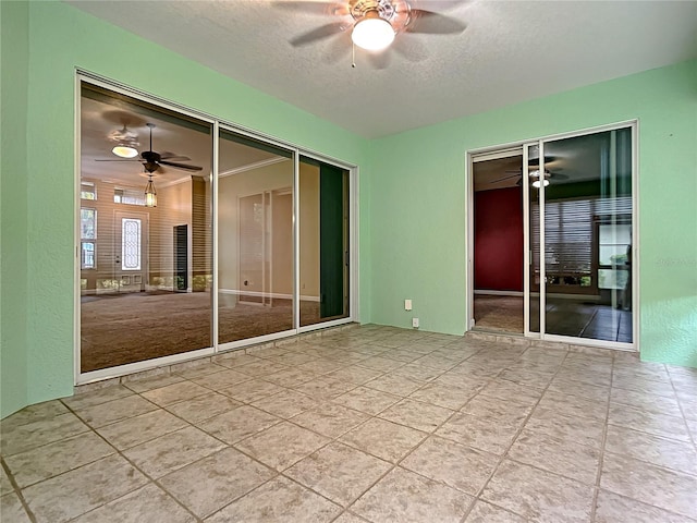 unfurnished bedroom with ceiling fan and a textured ceiling