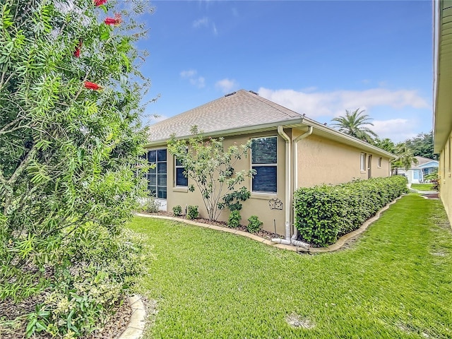 view of side of home with a lawn