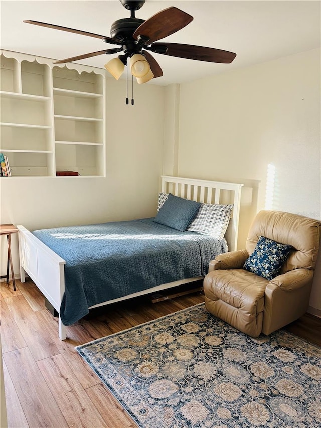 bedroom featuring hardwood / wood-style flooring and ceiling fan