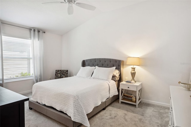 bedroom with ceiling fan, light colored carpet, and lofted ceiling