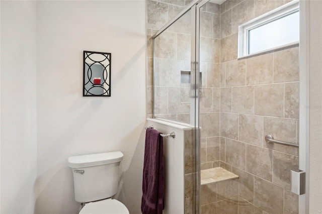 bathroom with walk in shower and toilet