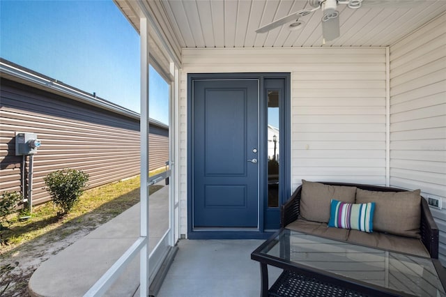 entrance to property featuring ceiling fan