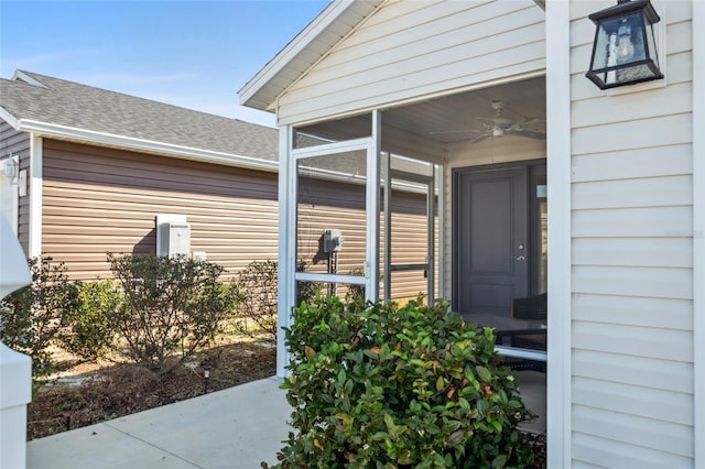 view of exterior entry with ceiling fan