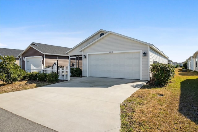 ranch-style home featuring a garage and a front lawn