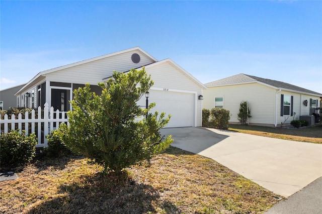 view of front of house featuring a garage, a sunroom, and central air condition unit