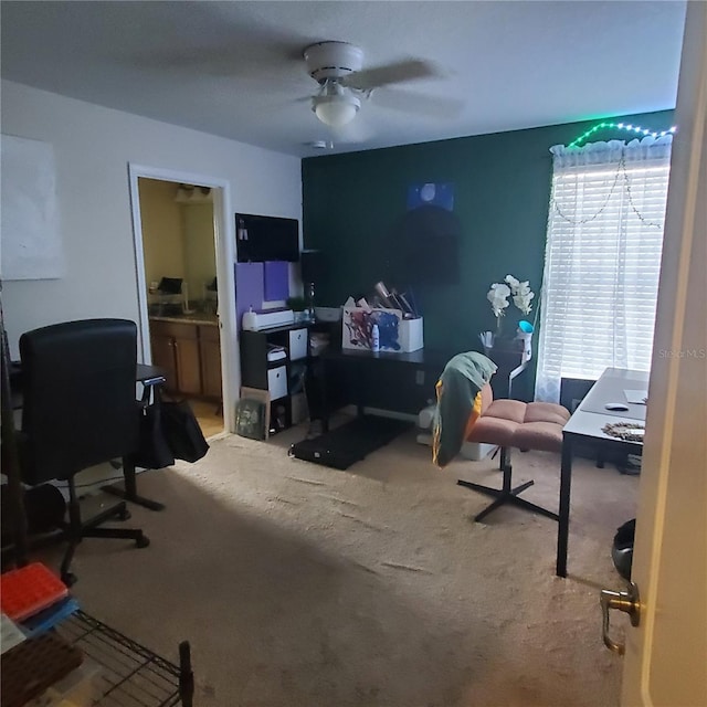 carpeted home office with ceiling fan