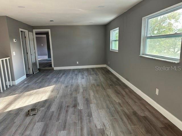 spare room with dark wood-type flooring