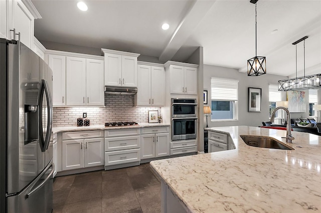 kitchen featuring decorative light fixtures, stainless steel appliances, and white cabinets