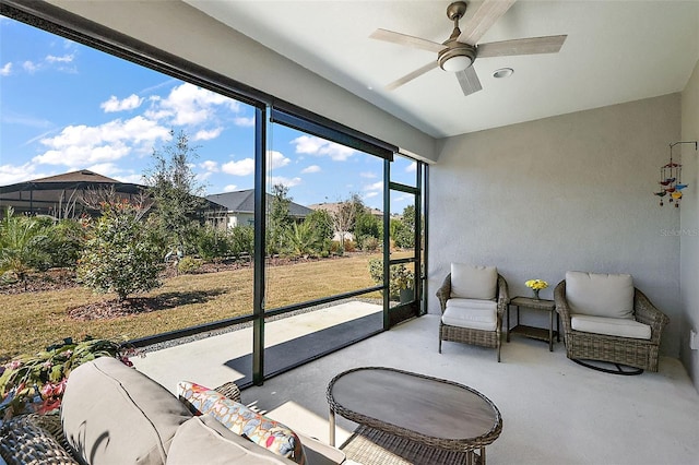 sunroom featuring ceiling fan