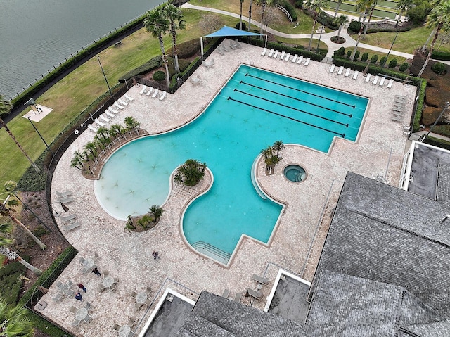 view of swimming pool featuring a water view