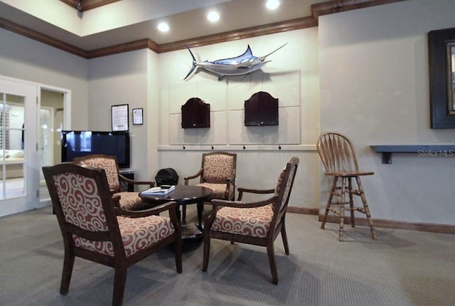 living area featuring crown molding and carpet floors