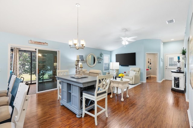 kitchen with hardwood / wood-style floors, lofted ceiling, a healthy amount of sunlight, and pendant lighting