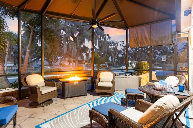4515 Biggs Pl, The Villages, FL 32163 - sunroom / solarium with tile patterned floors, floor to ceiling windows, ceiling fan, and an outdoor fire pit