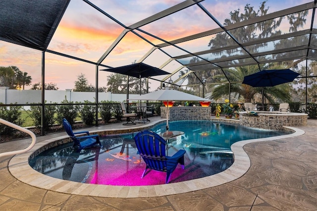 4515 Biggs Pl, The Villages, FL 32163 - pool at dusk featuring a fenced in pool, a lanai, and a patio area