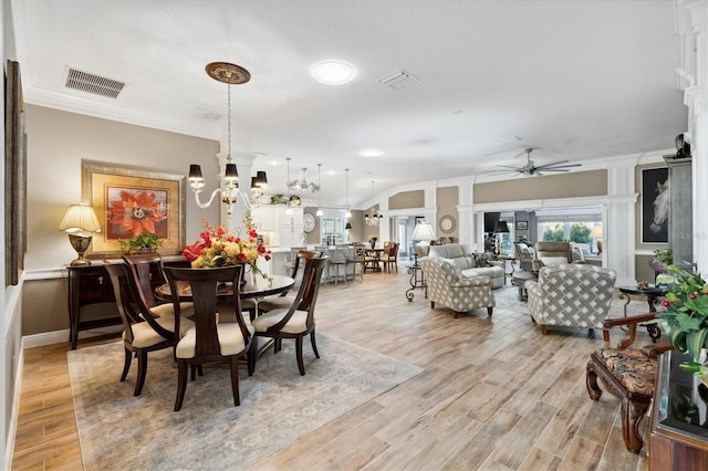 4515 Biggs Pl, The Villages, FL 32163 - dining area with ornamental molding, ceiling fan with notable chandelier, light wood-style flooring, and visible vents