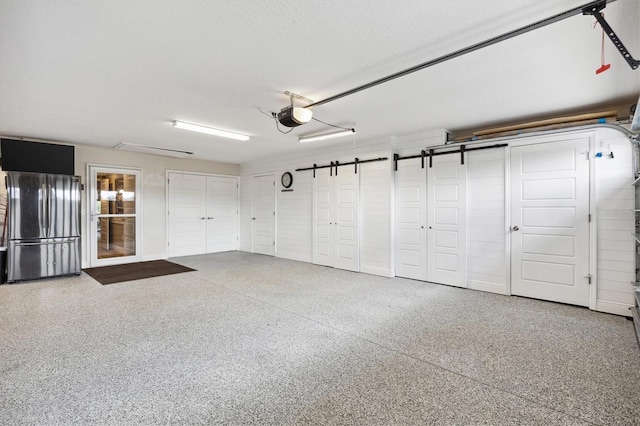 4515 Biggs Pl, The Villages, FL 32163 - garage with freestanding refrigerator and a garage door opener