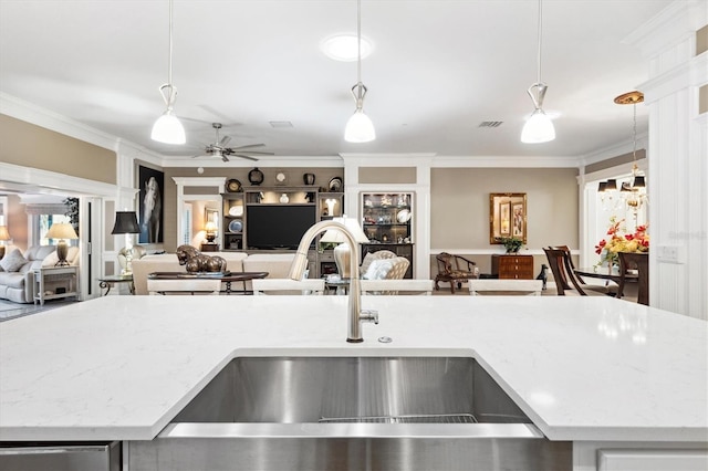 4515 Biggs Pl, The Villages, FL 32163 - kitchen featuring a sink, a ceiling fan, decorative light fixtures, and open floor plan